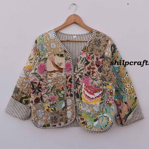 May include: A cream-colored quilted jacket with a floral print and a striped lining. The jacket has a V-neck and a button closure. The text "shilpcrafts" is visible on the right side of the image.