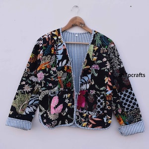 May include: A black quilted jacket with a floral print. The jacket has a V-neck and a striped lining.