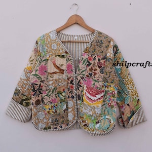 May include: A cream-colored quilted jacket with a floral print and a striped lining. The jacket has a V-neck and a button closure. The text "shilpcrafts" is visible on the right side of the image.