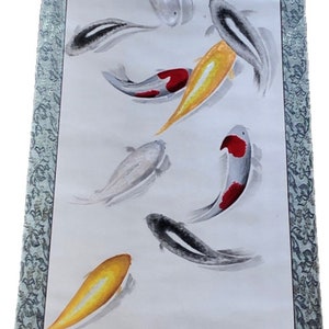 May include: A long, vertical scroll painting featuring koi fish in shades of orange, yellow, black, and white. The fish swim in a watery environment, with a decorative border. The artwork is in the style of traditional Asian art.