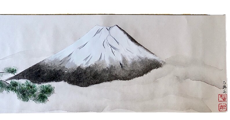 May include: Watercolor painting of Mount Fuji, a snow-capped mountain with a dark, shaded base. The artwork features a minimalist style with soft, gray tones and a touch of green foliage in the foreground. Japanese characters are in the lower right corner.