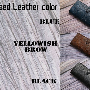 May include: Embossed leather wallets in blue, yellowish brown, and black. Each wallet features a floral pattern and a snap closure. The image also includes the text "Embossed Leather color" and the color names.
