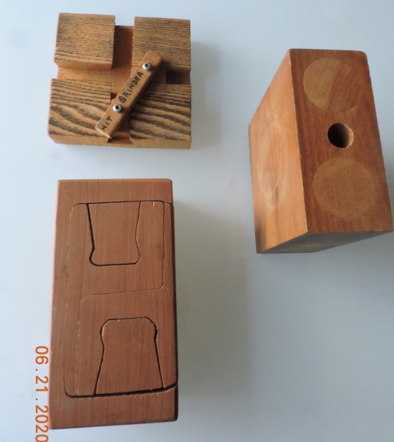 three wooden puzzles