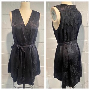 Handmade black floral print wrap dress with fringe detail.