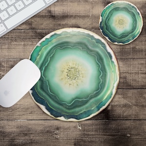 May include: A green and white agate slice mouse pad with a circular design. The mouse pad is on a wooden surface.