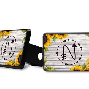 Sunflower Trailer Hitch Cover on Gray Wood