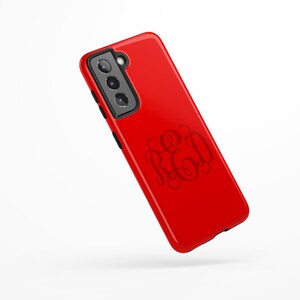 May include: Red phone case with a black camera bump and a monogrammed design that says "RED".