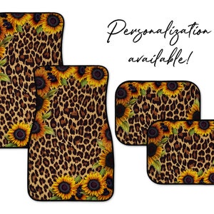 May include: Set of four car floor mats with a leopard print background and sunflower accents. The mats are black with a black border. Personalization available.