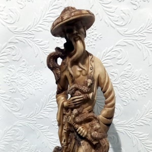 Vintage statue figuring an Asian man