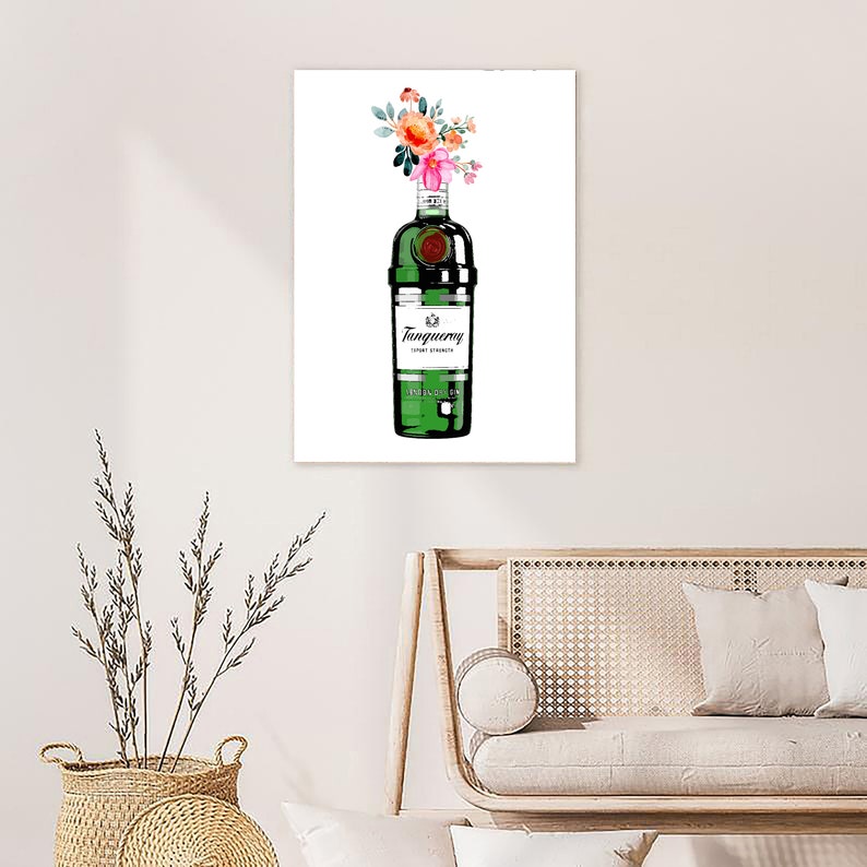May include: A green glass bottle of Tanqueray London Dry Gin with a bouquet of pink and orange flowers on top. The bottle has a white label with the brand name and "London Dry Gin" printed on it.