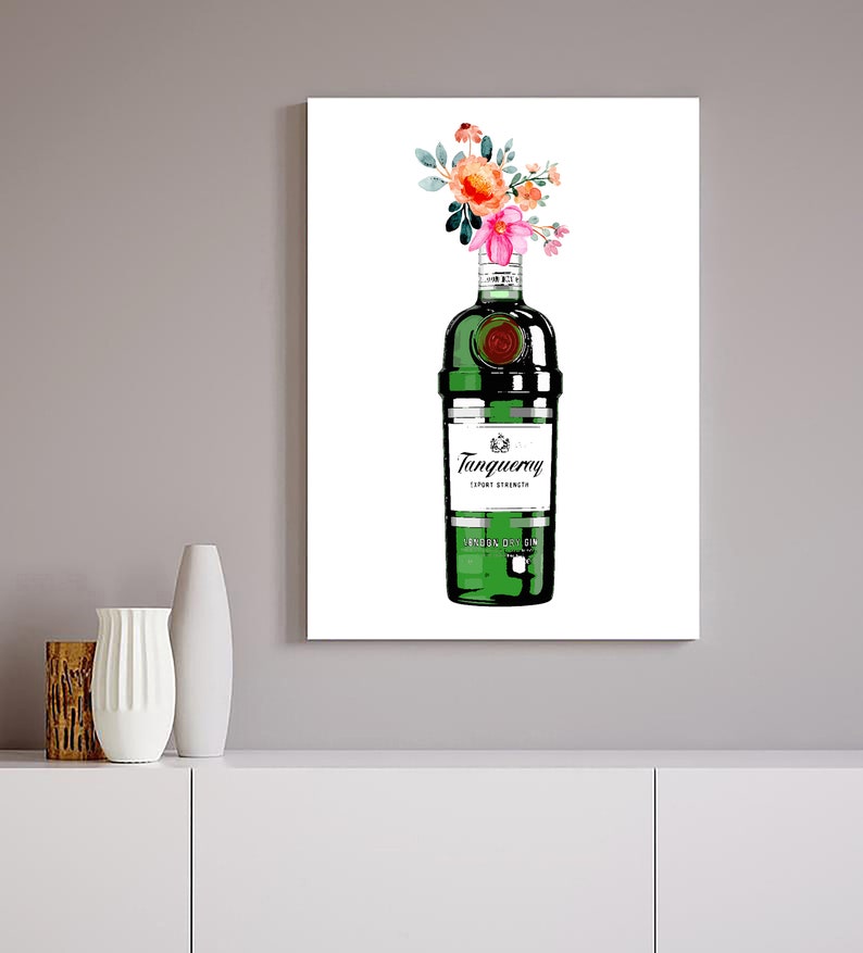May include: A green glass bottle of Tanqueray London Dry Gin with a bouquet of pink and orange flowers in the top. The bottle has a white label with the brand name and "London Dry Gin" printed on it.