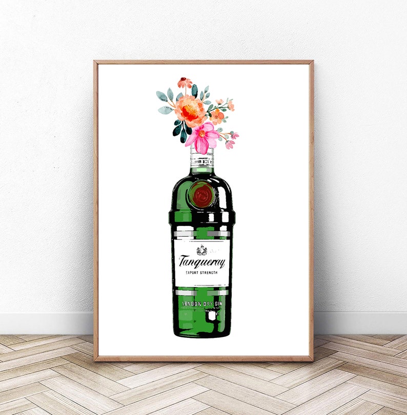 May include: A green glass bottle of Tanqueray London Dry Gin with a floral arrangement of pink, orange, and green flowers in the top of the bottle.