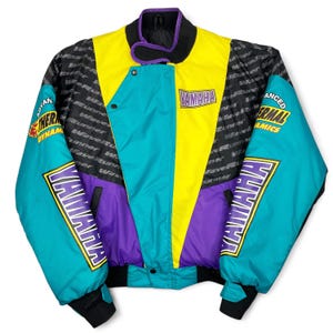 May include: A vintage Yamaha racing jacket in a vibrant color block design. The jacket features teal, yellow, purple, and black panels with Yamaha branding and "Wave Runner" text. It has a stand-up collar and a snap closure.