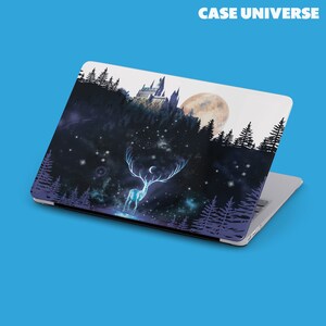 May include: A laptop skin with a dark blue and purple background featuring a white stag with antlers, a crescent moon, and a castle in the distance. The background is filled with stars and a large moon.
