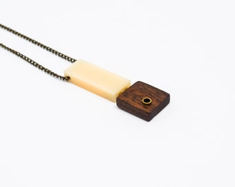 Wooden necklace with cream acrylic and brass details
