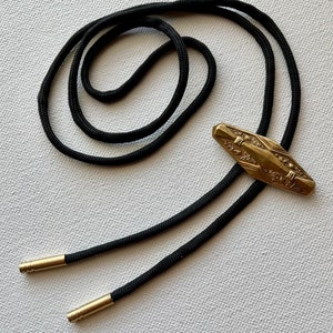 Vintage Brass Bolo on black Nylon Cord