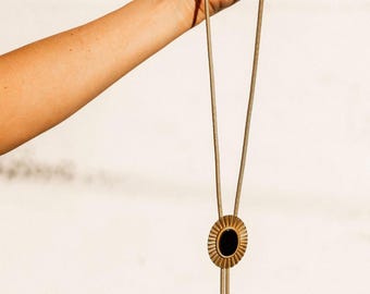 Brass and black onyx stone sunburst bolo tie necklace