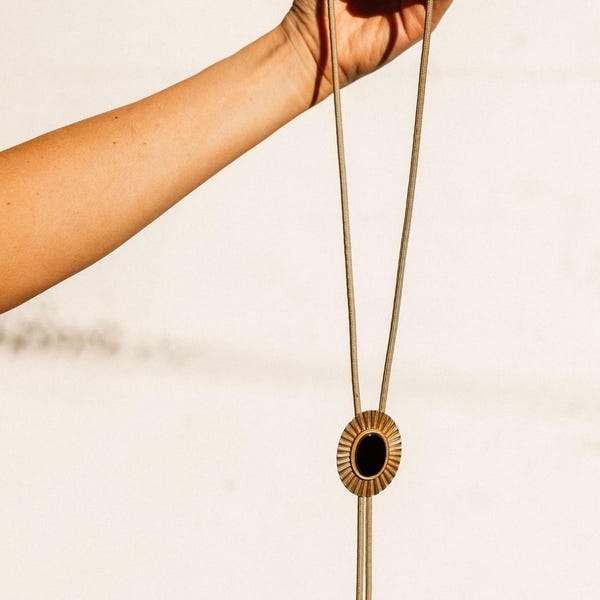 Brass and black onyx stone sunburst bolo tie necklace