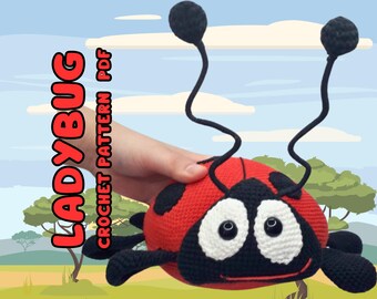 May include: A crocheted ladybug toy with black legs, antennae, and eyes. The ladybug is red with black spots and has a white face.
