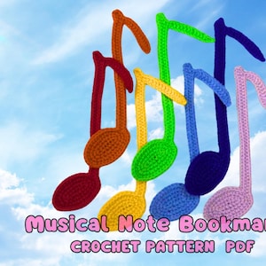 May include: A set of six colourful crocheted musical note bookmarks. The notes are in a rainbow pattern, with red, orange, yellow, green, blue, and pink. The bookmarks are arranged in a row, with the red note at the top and the pink note at the bottom. The background is a blue sky with white clouds. The text "Musical Note Bookmarks CROCHET PATTERN PDF" is at the bottom of the image.