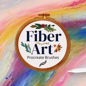 May include: A wooden embroidery hoop featuring the text "Fiber Art Procreate Brushes" in navy blue, with floral and leaf illustrations. The background is a colourful, abstract blend of pink, yellow, and blue.