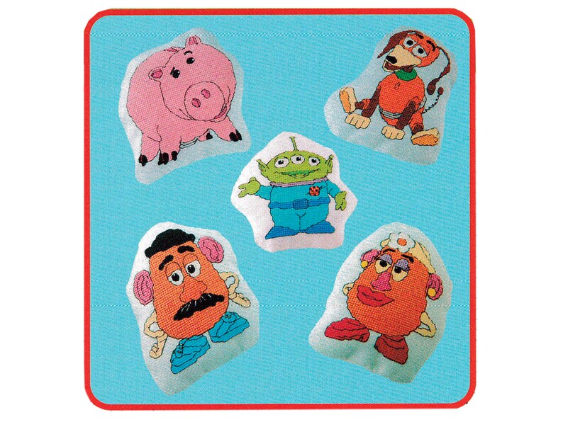May include: Five plush toys from the Toy Story franchise. The toys are on a blue background. The toys are: a pink pig, a green alien, a brown potato head, a red potato head, and an orange dog.