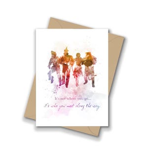 May include: Greeting card featuring a watercolor illustration of characters from The Wizard of Oz. The image includes the Tin Man, Scarecrow, Lion, and Dorothy. The card has the quote, "It's not where you go... it's who you meet along the way."