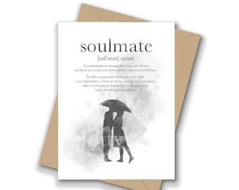 May include: A white greeting card featuring the dictionary definition of the word soulmate, including its phonetic spelling and a definition text. Below the text is a gray watercolor illustration of two figures standing under an umbrella.