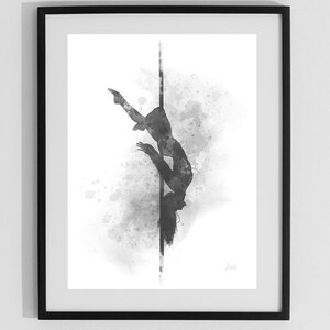 May include: Black and white watercolor illustration of a person performing a pole dance pose. The image is framed in a black frame. The text "FRAME NOT INCLUDED" is printed below the frame.