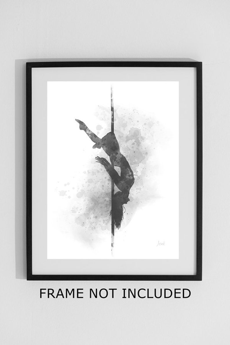 May include: Black and white watercolor illustration of a person performing a pole dance pose. The image is framed in a black frame. The text "FRAME NOT INCLUDED" is printed below the frame.