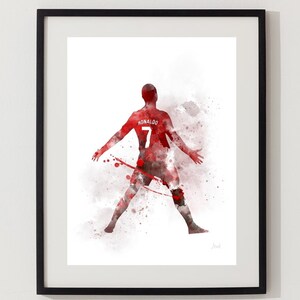 May include: A watercolor painting of a soccer player in a red jersey with the name "RONALDO" and the number "7" on the back. The player is in a dynamic pose with arms outstretched, against a white background with red watercolor splatters.