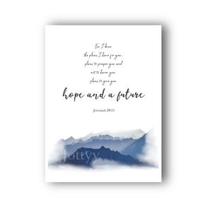 May include: A white rectangular wall art print featuring a watercolour mountain landscape in shades of blue at the bottom. The text reads: For I know the plans I have for you... plans to prosper you and not to harm you, plans to give you hope and a future. Jeremiah 29:11.