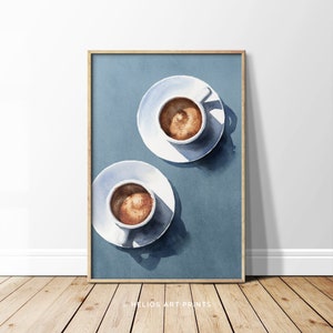 May include: Two white ceramic cups filled with coffee on white saucers, set against a blue watercolor background.