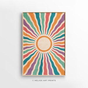 May include: A retro-style sunburst print with a circular sun in the center. The sunburst is made up of wavy lines in shades of orange, red, purple, teal, and green.