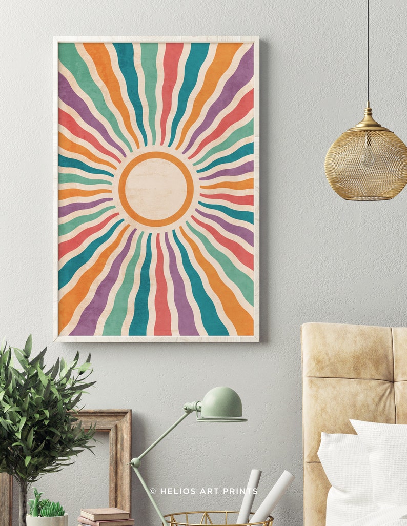 May include: A retro-style sunburst print with a white circle in the center. The sunburst is made up of colorful stripes in shades of orange, red, purple, teal, and green.
