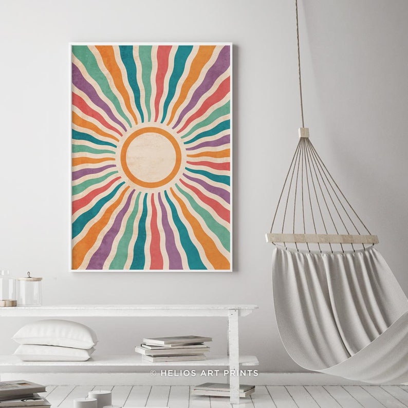 May include: A colorful abstract sunburst print with a white background and a circle in the center. The sunburst is made up of wavy lines in shades of orange, red, purple, teal, and green. The print is framed in a white frame. The text "HELIOS ART PRINTS" is at the bottom of the print.