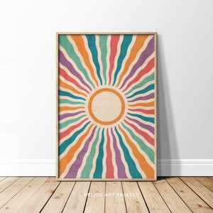 May include: A retro-style sunburst print with a colorful design of wavy lines in shades of orange, red, purple, teal, and green. The sunburst design is centered around a circle with a beige background.
