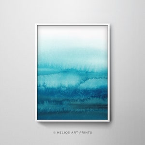 May include: Abstract watercolor painting in shades of blue, with a white frame. The painting depicts a gradient of blue hues, transitioning from light to dark, creating a sense of depth and movement. The artwork is framed in a simple white frame, adding a touch of elegance.