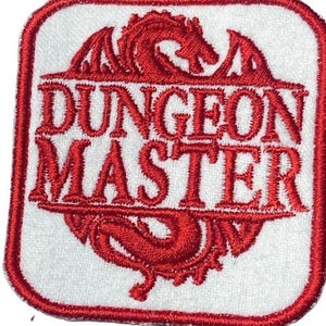 May include: Red embroidered patch with a white background. The patch features a red dragon and the text "DUNGEON MASTER".