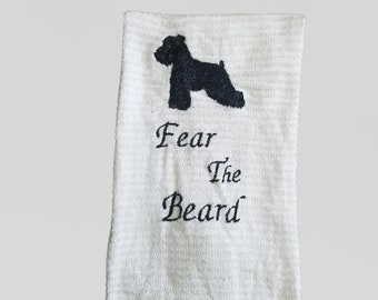 May include: White kitchen towel with a black silhouette of a dog and the text "Fear The Beard".