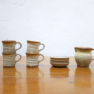 Series of 4 cups and a vintage stoneware milk jug