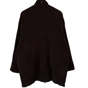 May include: A dark brown quilted jacket with a high collar and a zip closure.
