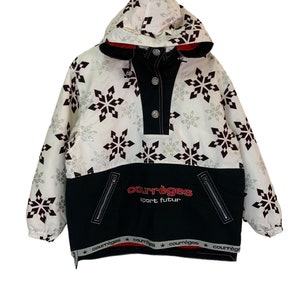 May include: White hooded jacket with a black and white snowflake pattern. The jacket has a black zipper and a black and red logo that says "Courr&egrave;ges Sport Futur".