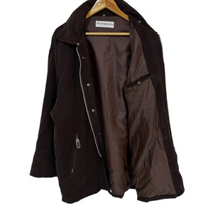 May include: A brown corduroy jacket with a zip fastening and a single pocket on the left side. The jacket is lined with a brown fabric and has a label that reads "Contemporary Classics".