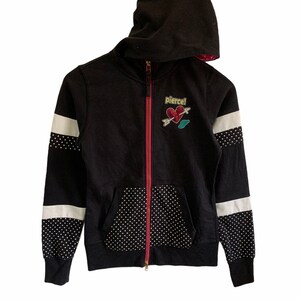 May include: Black zip-up hoodie with white and black polka dot accents. The hoodie has a red zipper and a heart with an arrow graphic that says "Pierce!"