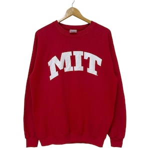 Puede incluir: Sudadera roja con un logotipo blanco de MIT en la parte delantera.