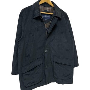 May include: A black jacket with a zip and button fastening. The jacket has two large pockets on the front and a plaid lining.