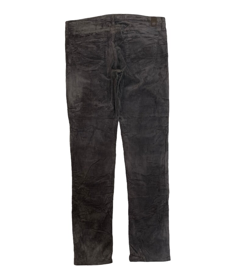 May include: Dark gray corduroy pants with a slim fit. The pants have a textured surface and a slightly distressed look.