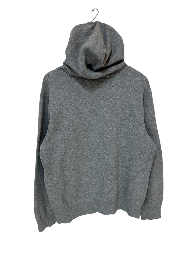 May include: A gray hooded sweatshirt with a high neckline and long sleeves.