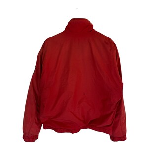 May include: A red jacket with a zip fastening and a high collar.